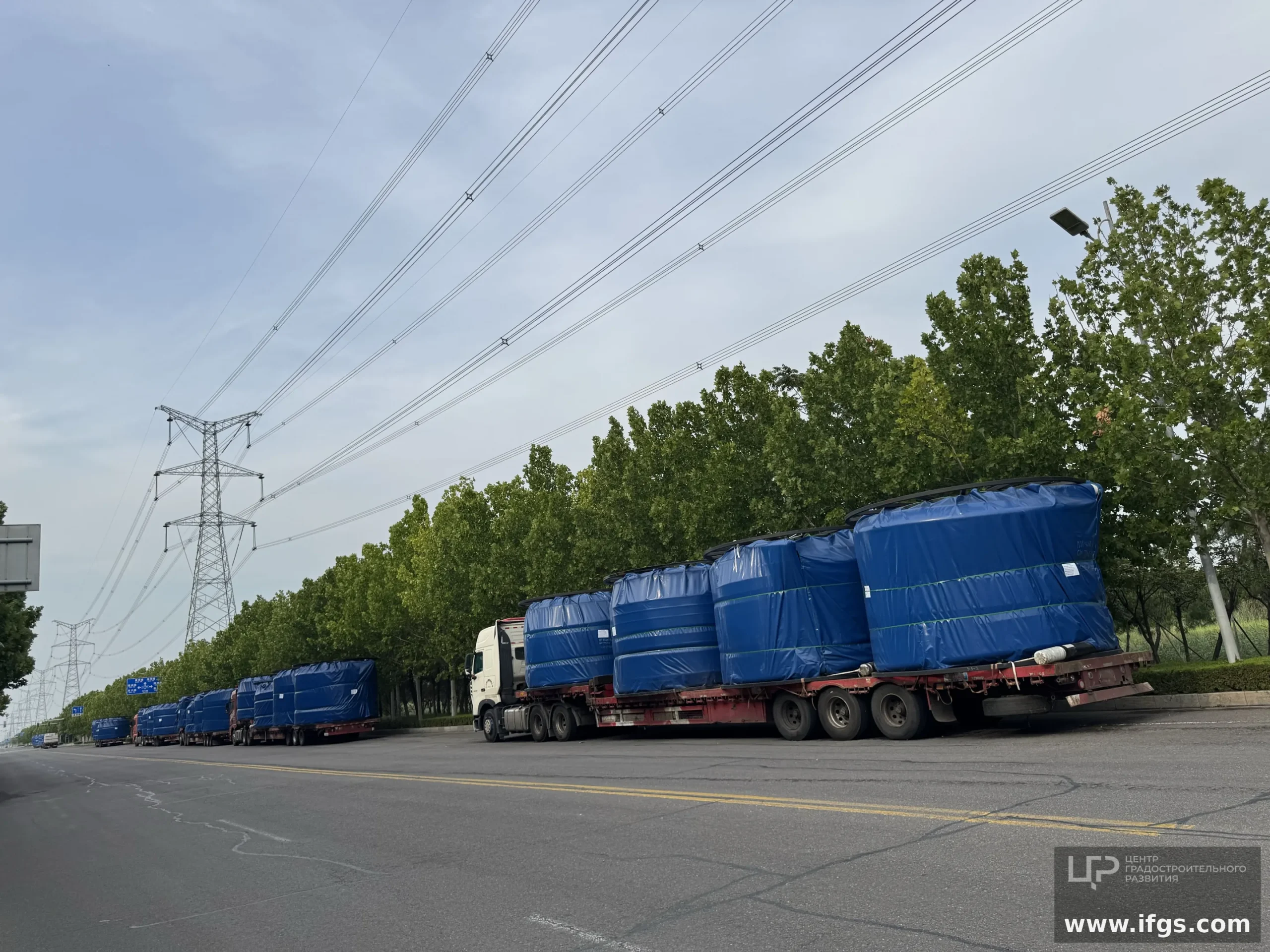 Blue-tarped RTP spools on highway flatbeds